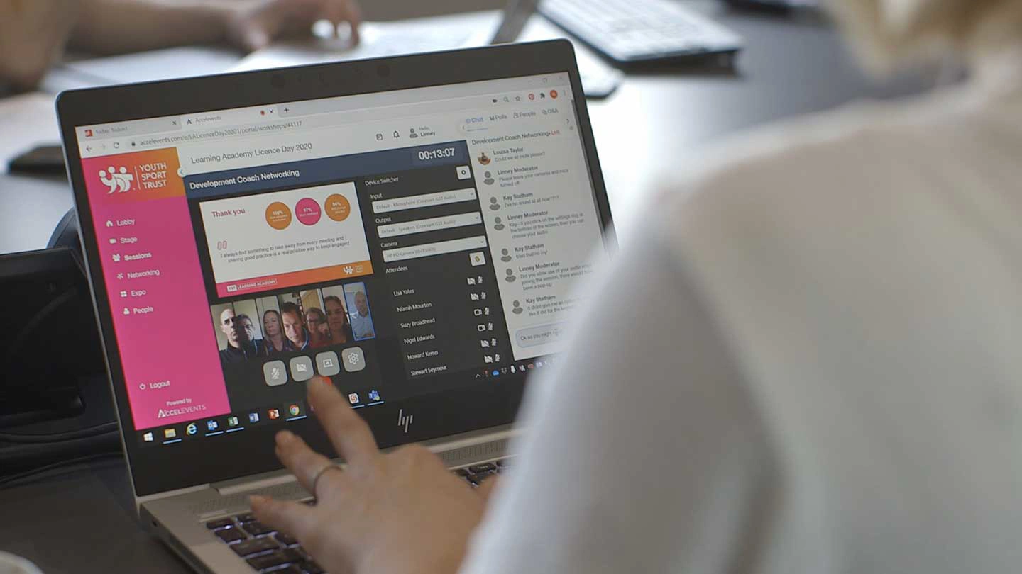 Person typing on a computer looking at the Youth Sports Trust website