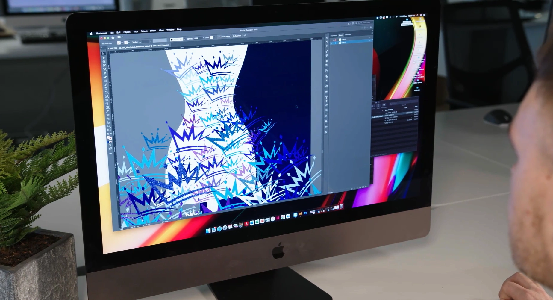 Person working on a computer creating the Cinderella dress design