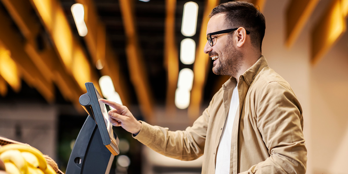 Man shopping using touchscreen