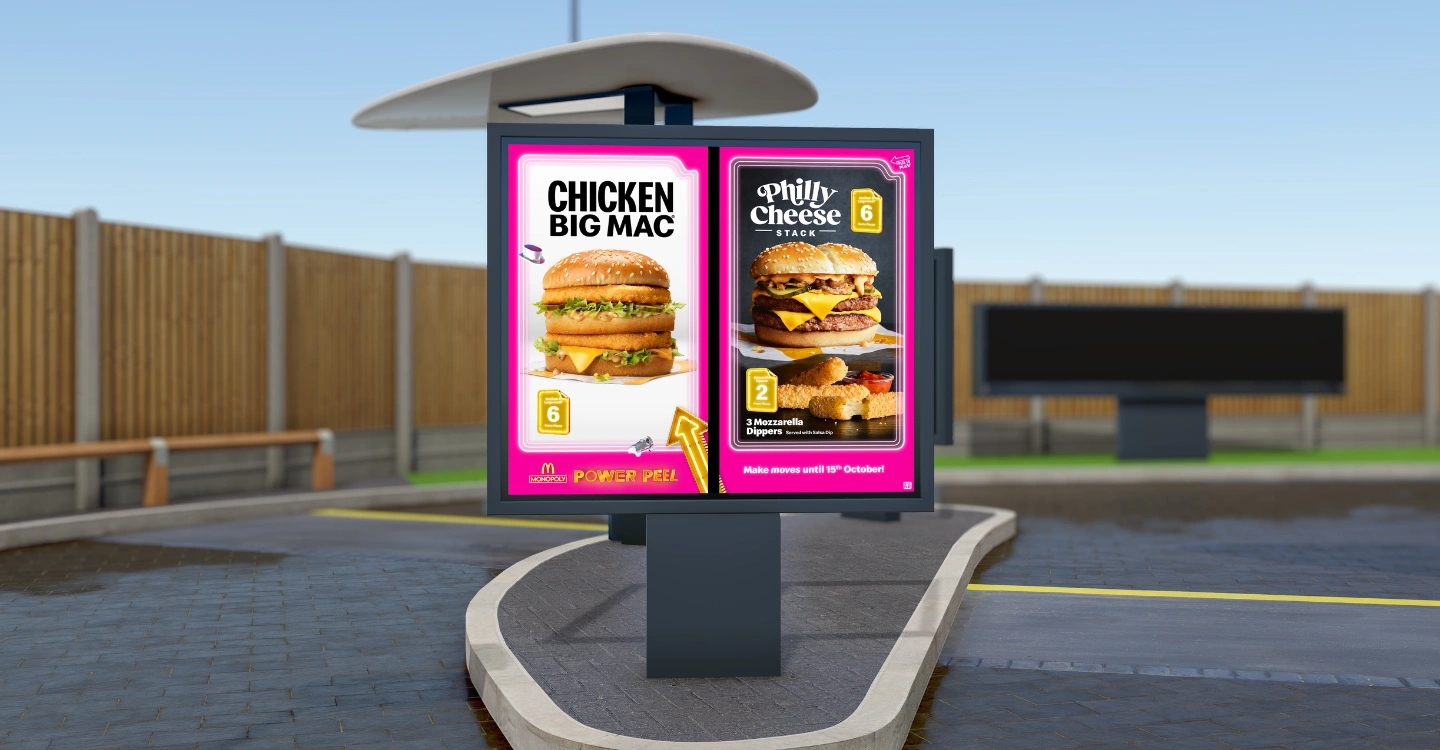 McDonald's digital signage at the drive thru, with the pink monopoly campaign on the screen