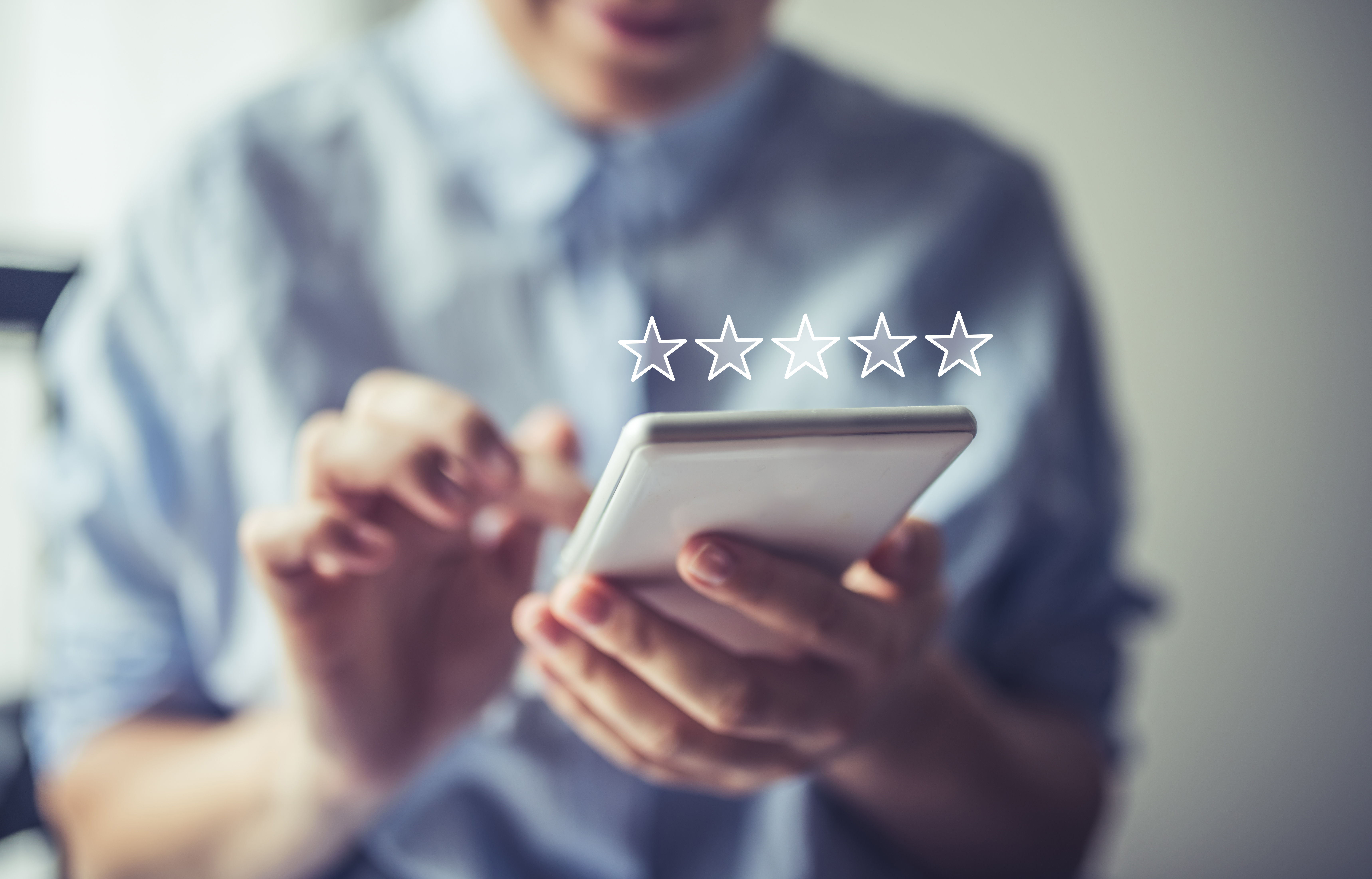 Man reviewing on phone with stars