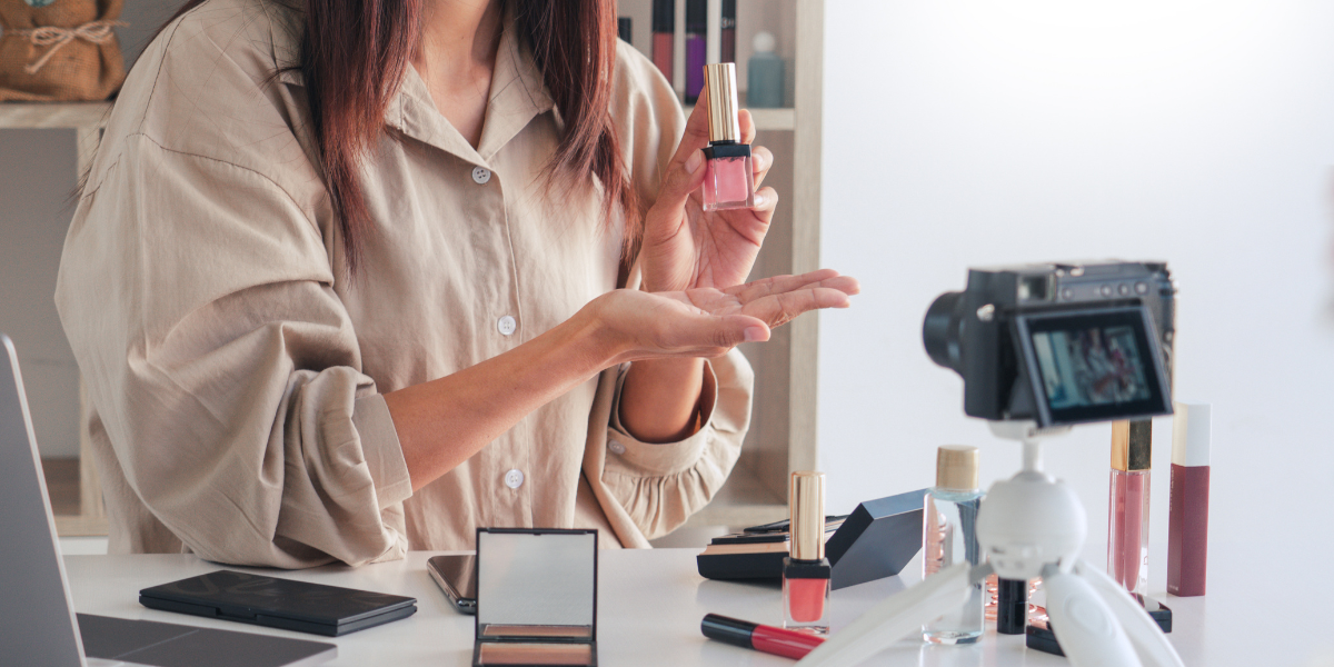 Influencer showing off beauty product to a camera