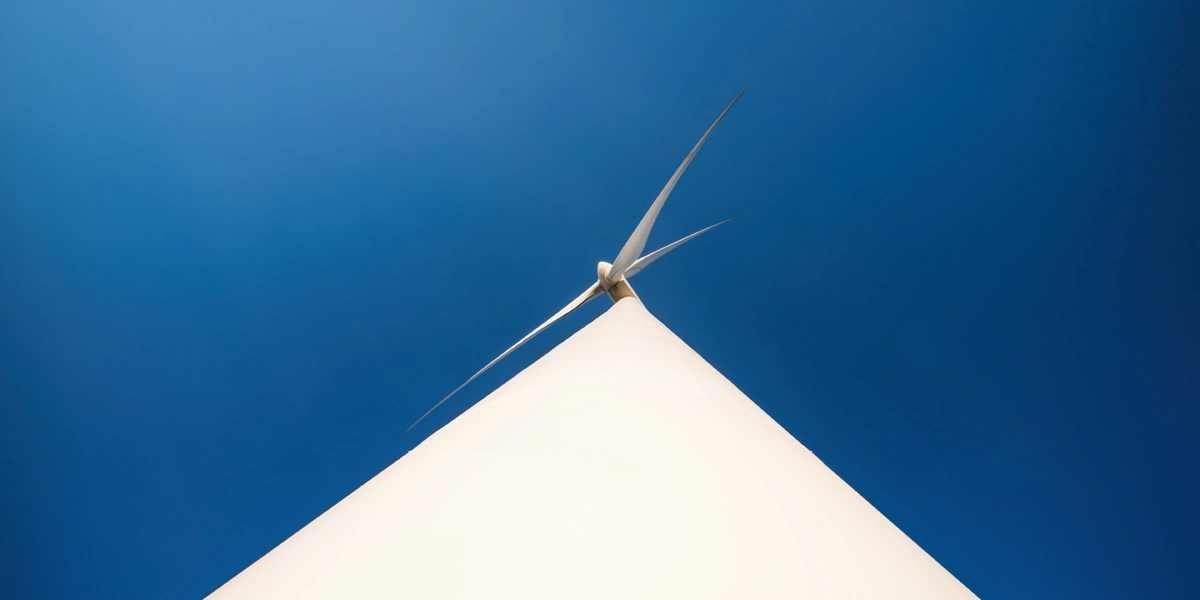 Looking up at a wind turbine