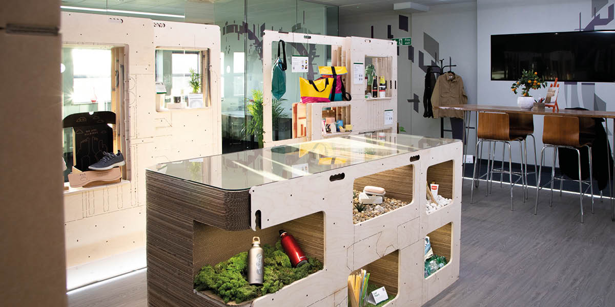 A room with cardboard table and shelving 