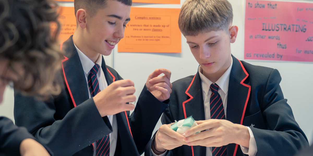 Male students crafting with a green sponge 