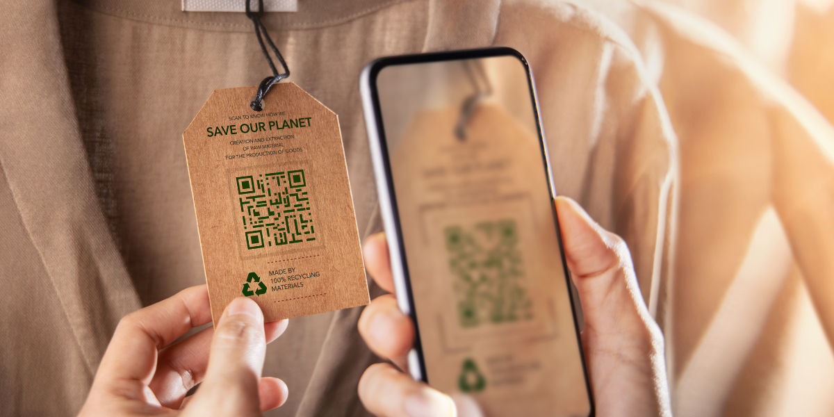 Mobile scanning a QR code on clothes tag which states save our planet