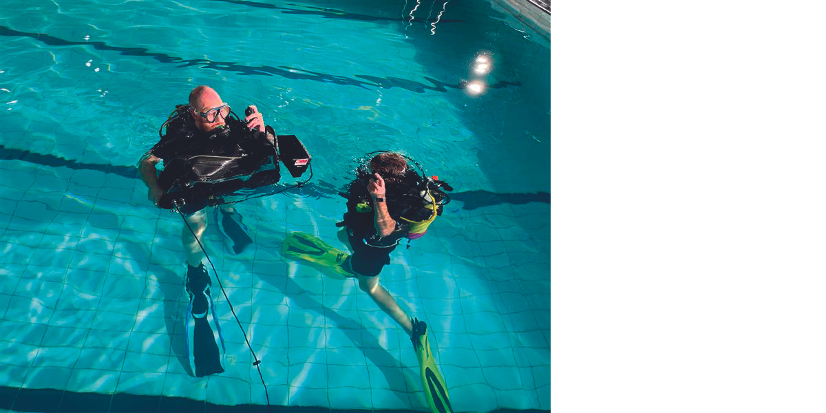 two divers with camera equipment