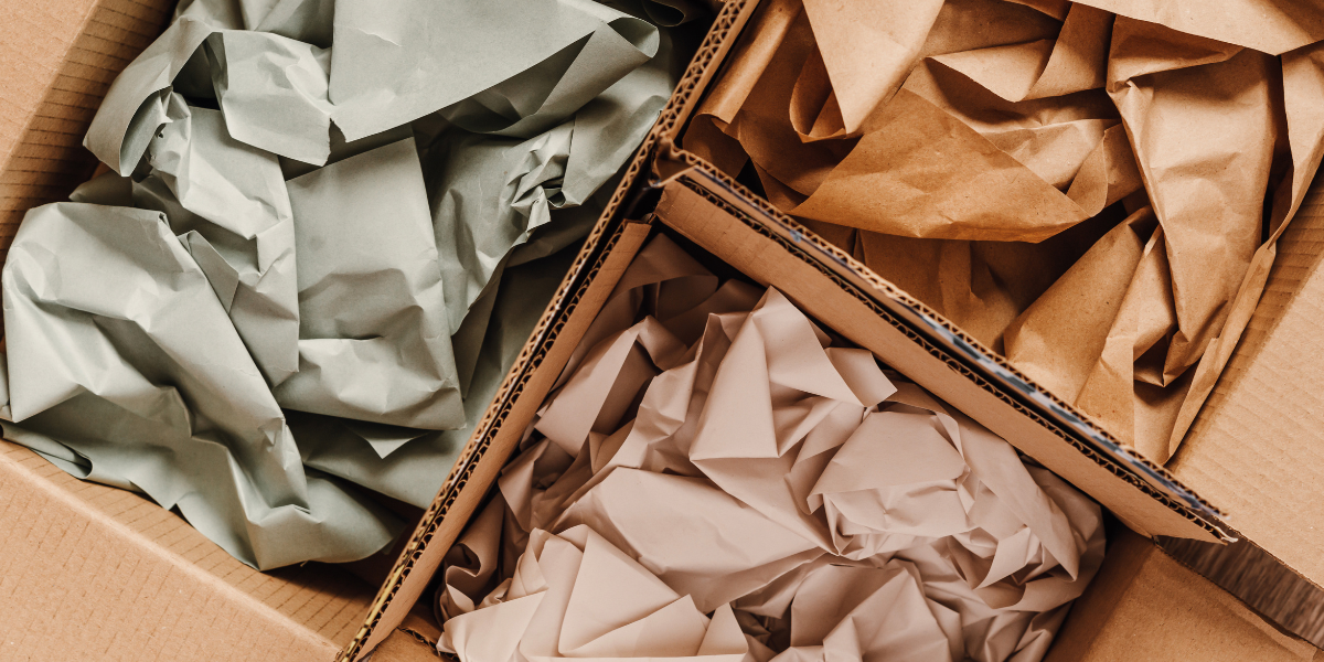 3 boxes filled with different coloured packaging paper