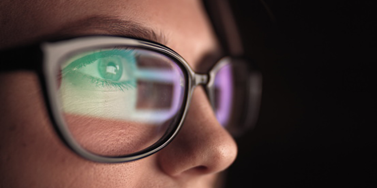 Person wearing glasses reflecting screen in them