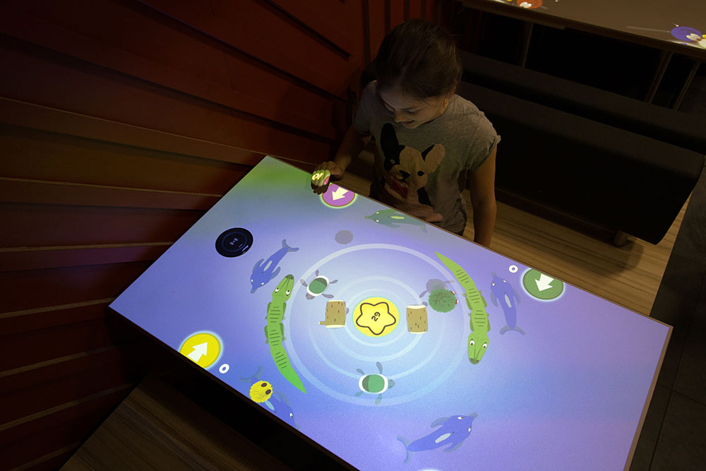 Child playing McDonald's interactive table game