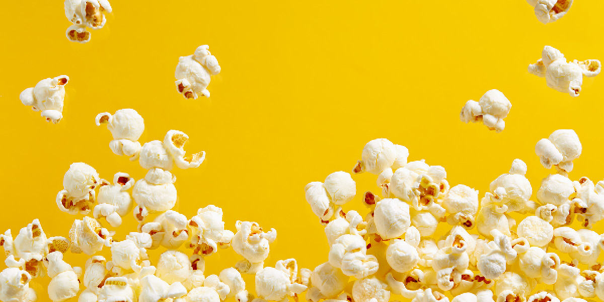 Popcorn popping against a yellow background
