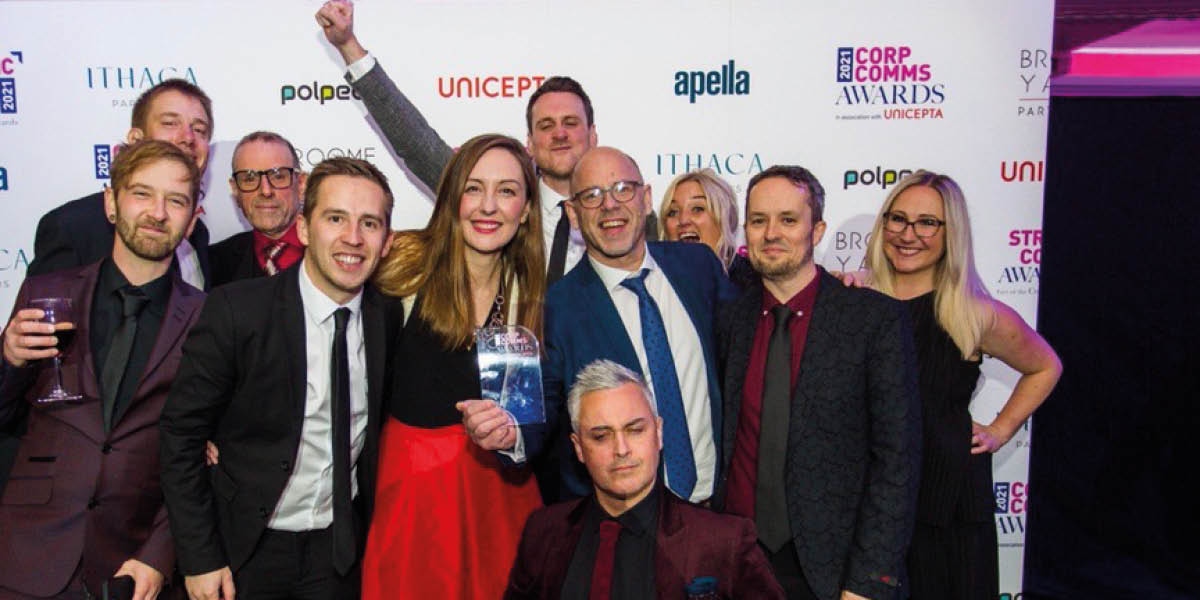 People smartly dressed celebrating an award win