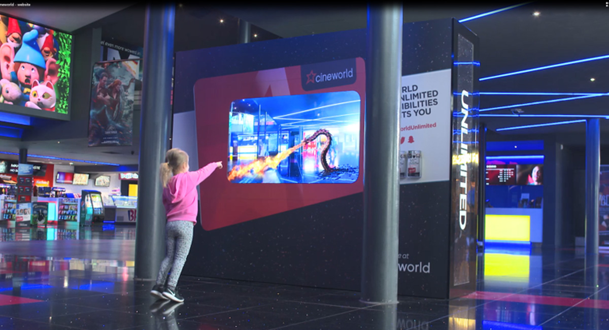 Child interacting with a digital screen in Cineworld
