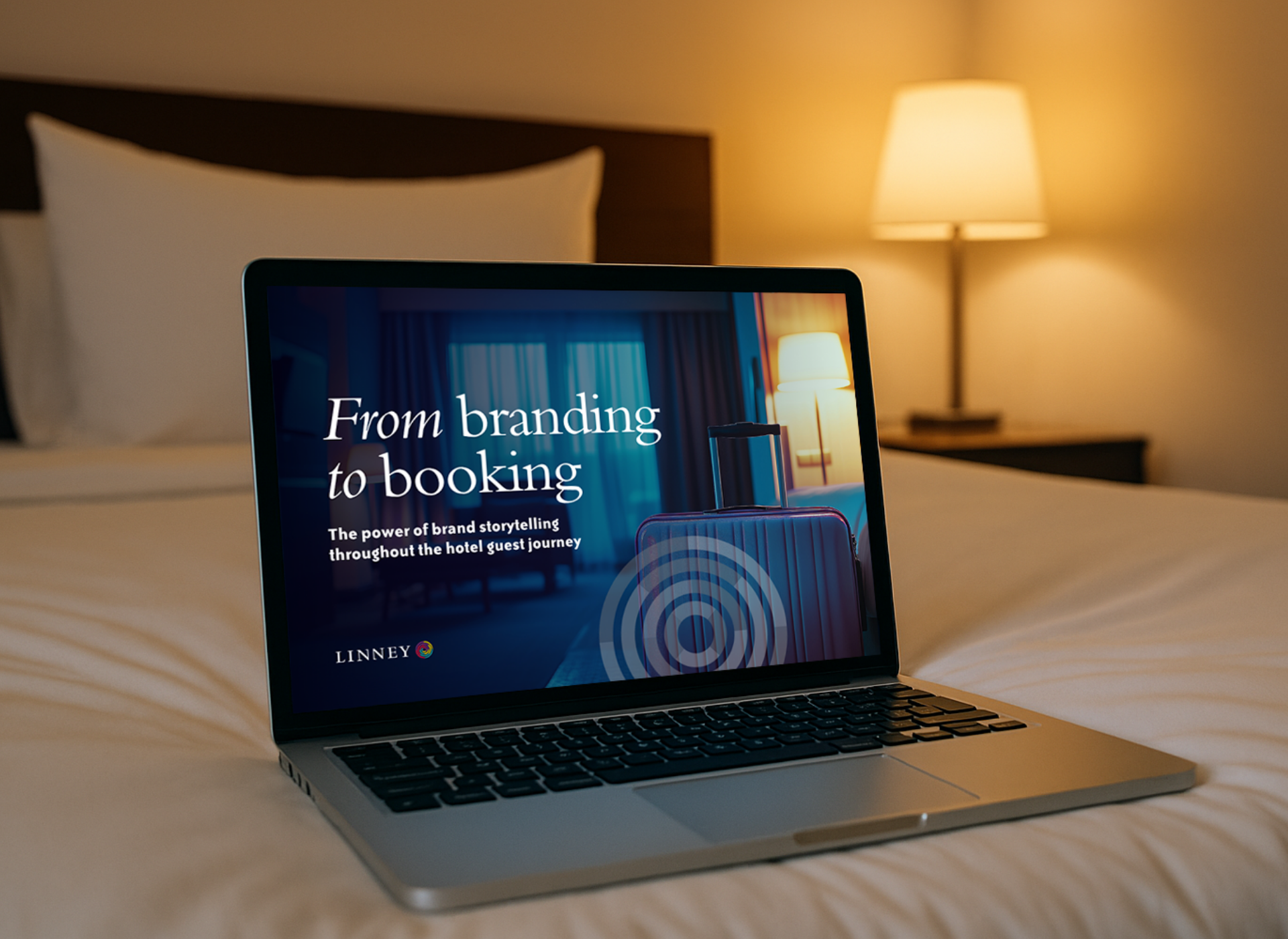 Laptop screen showing document cover on hotel bed