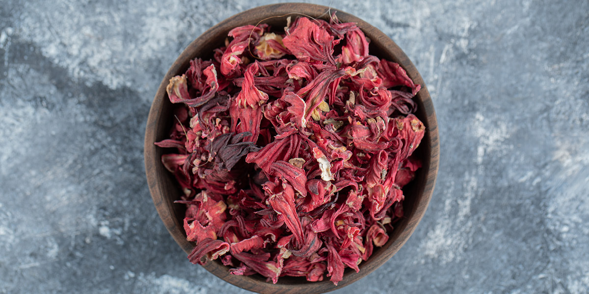 Bowl of hibiscus flower on a slate worktop